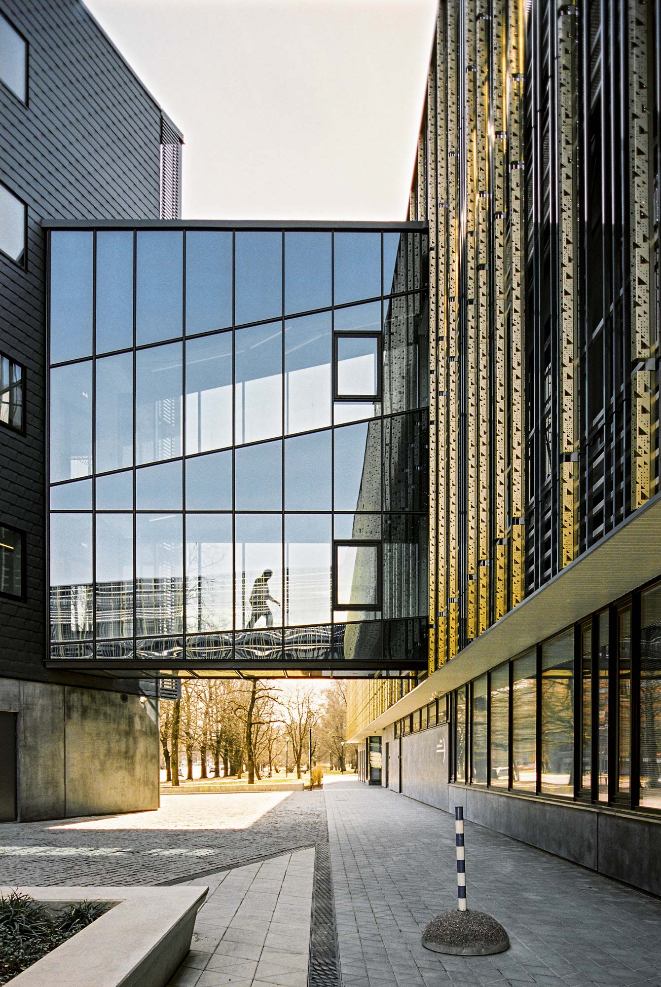 Mirrored bridge in building with man woking in between
