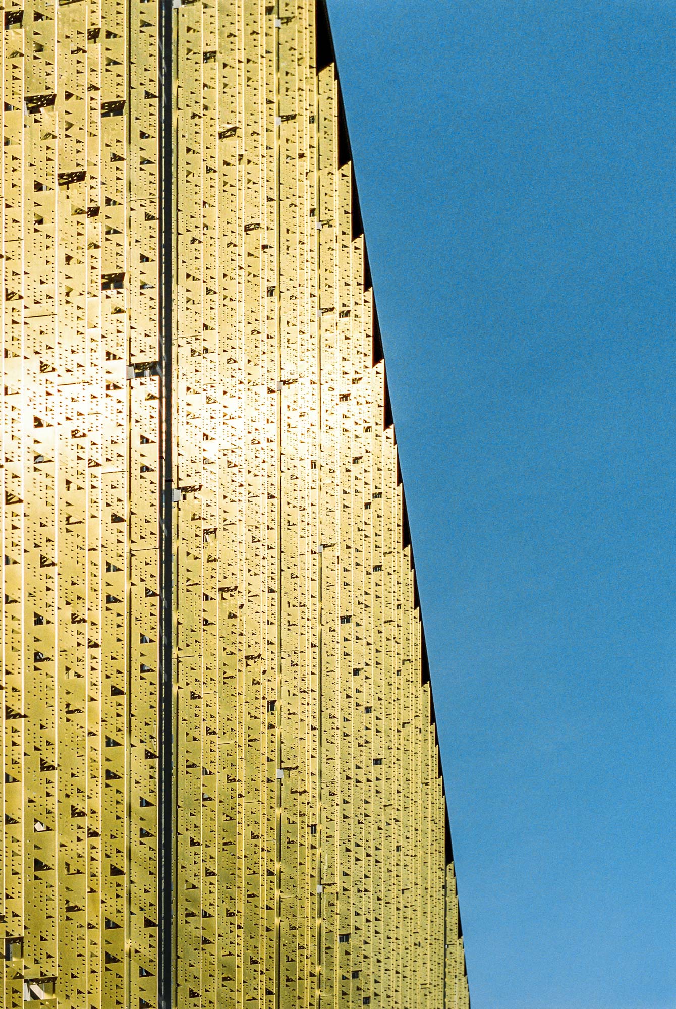 Perforated golden metal cladding in a building in Tartu, Estonia