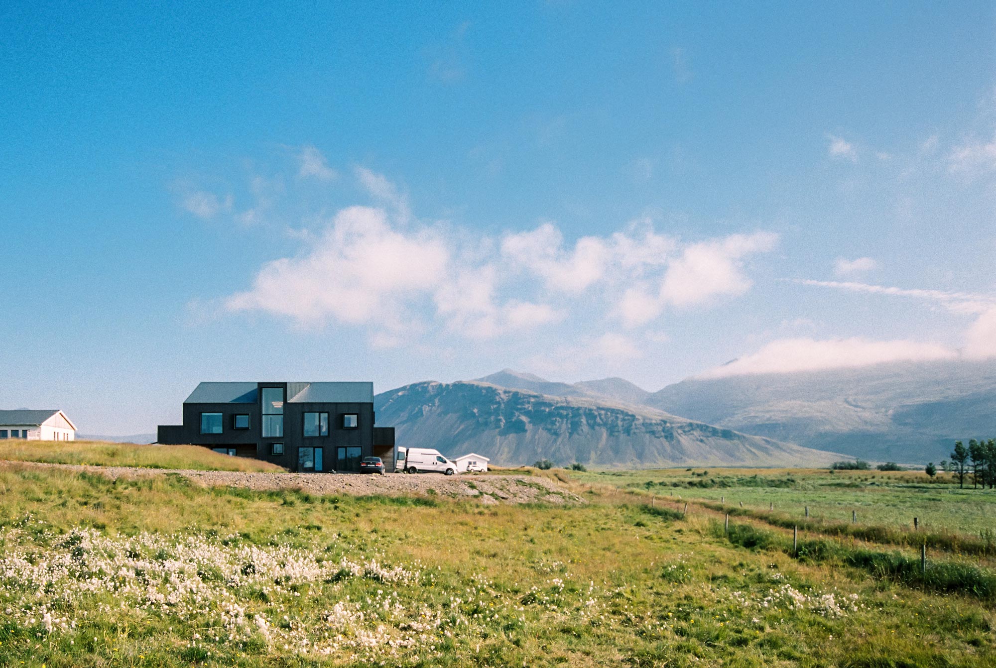 Modern architecture home in Iceland black metal cladding big mountains