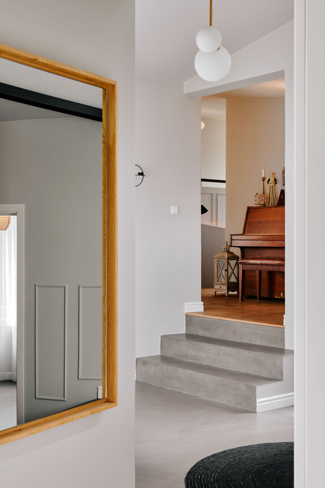 Japandi interior with big mirror wooden piano and small staircase