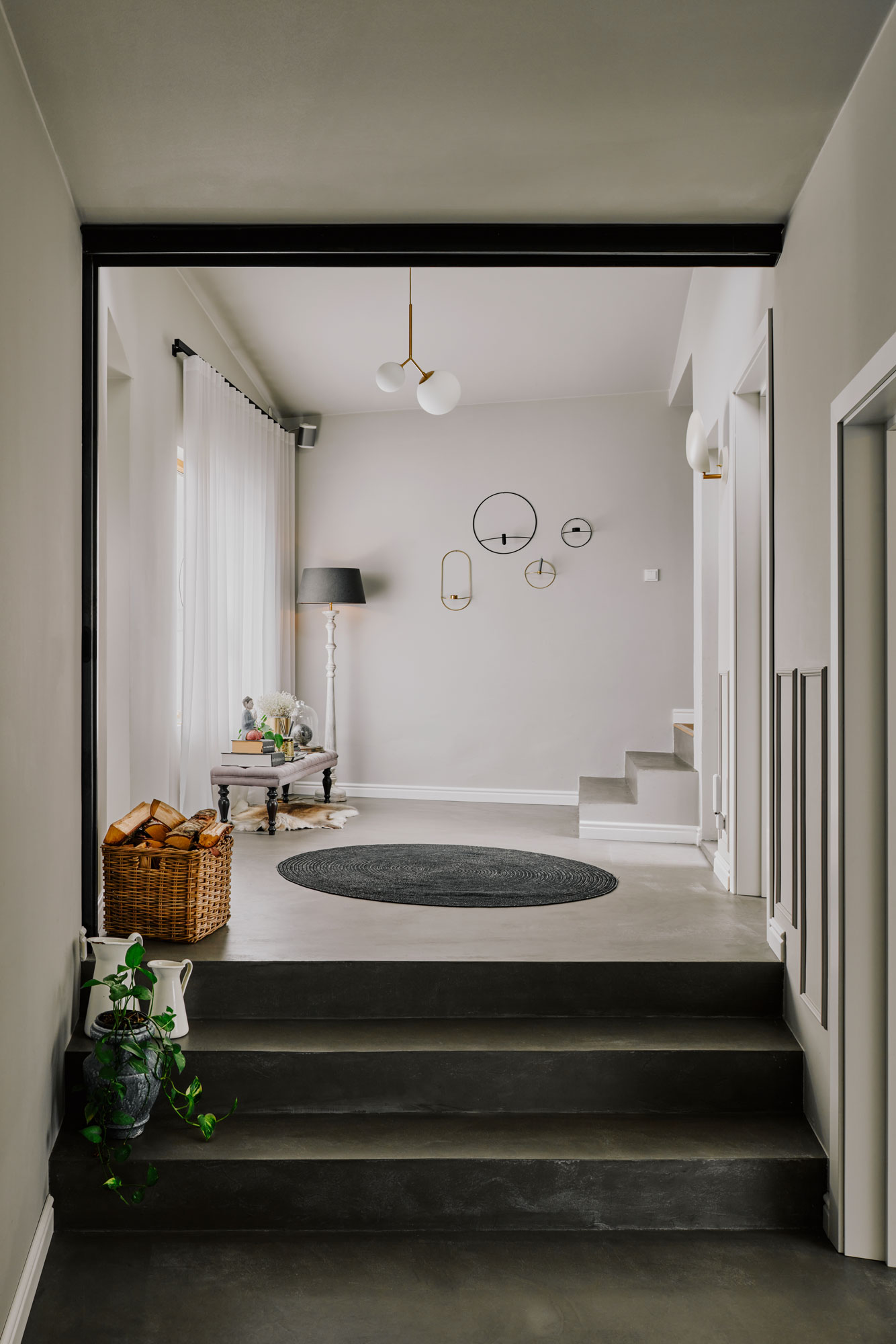 Minimal interior with small staircase circular carpet and wooden basket