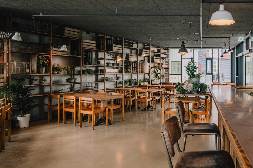 Brewery with wooden furniture and shelves with plants