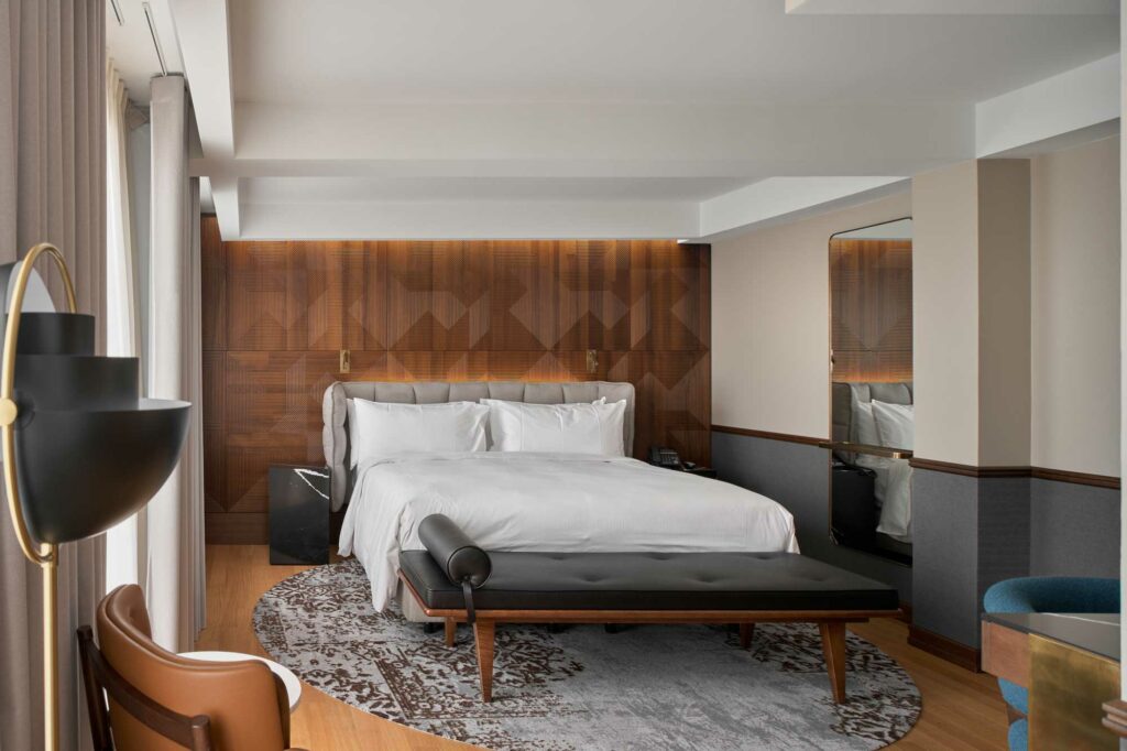 Hotel room with king size bed wooden walls and wooden floors