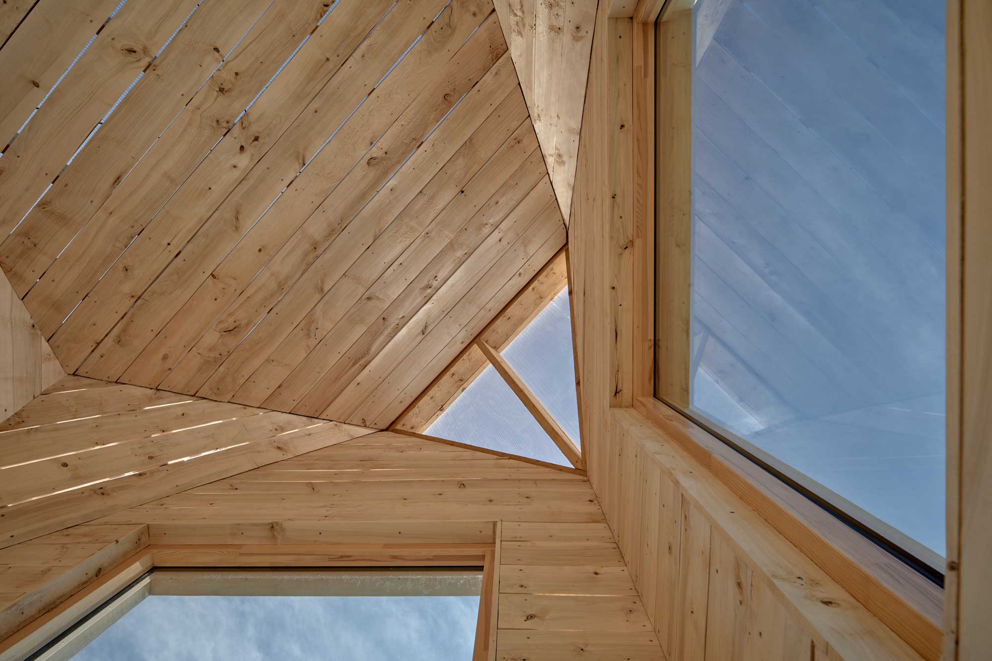 Wooden interior with large windows and clear blue skies