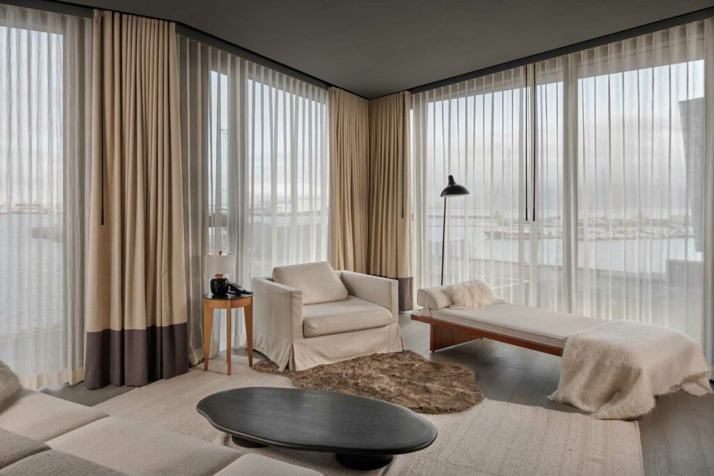 Luxury hotel room with sofa and large windows
